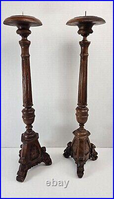 Pair of antique hand carved wooden candlestick holders used in church alter