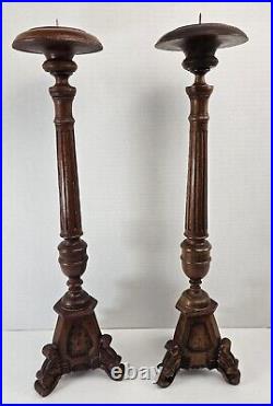 Pair of antique hand carved wooden candlestick holders used in church alter