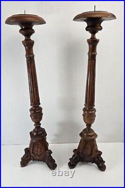 Pair of antique hand carved wooden candlestick holders used in church alter