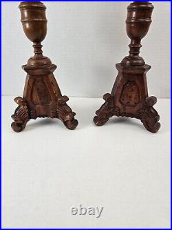 Pair of antique hand carved wooden candlestick holders used in church alter