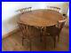 Round-oval-drop-leaf-vintage-Ercol-elm-dining-table-With-X4-Candlestick-Chairs-01-xv